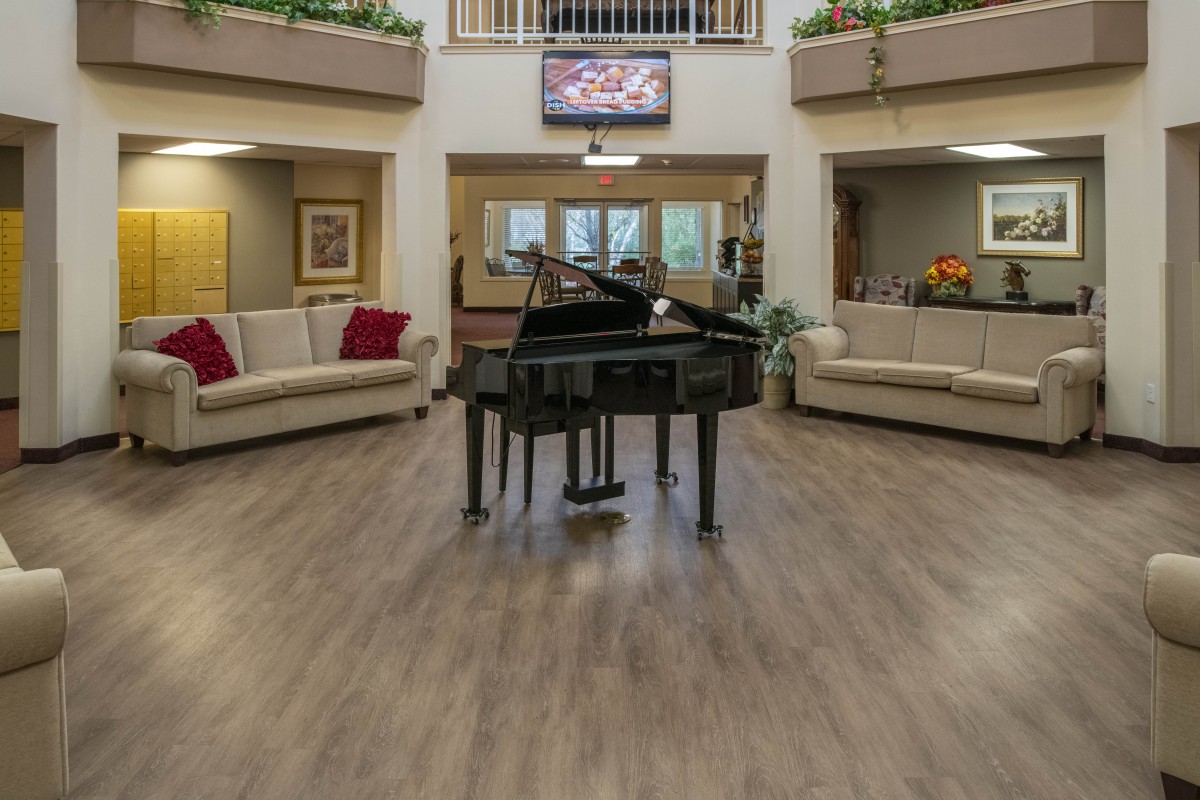 A modern lobby featuring a grand piano and comfortable seating.