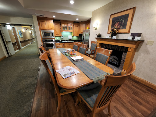 A cozy dining area featuring a wooden table and chairs, integrated with a kitchen space.