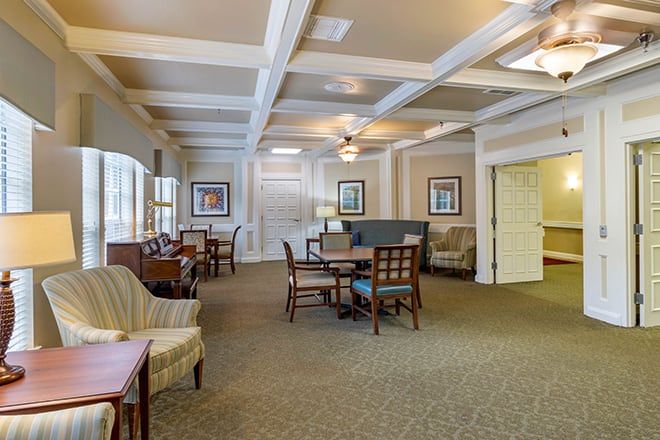 A cozy interior space with seating and tables, featuring a warm decor and comfortable furnishings.
