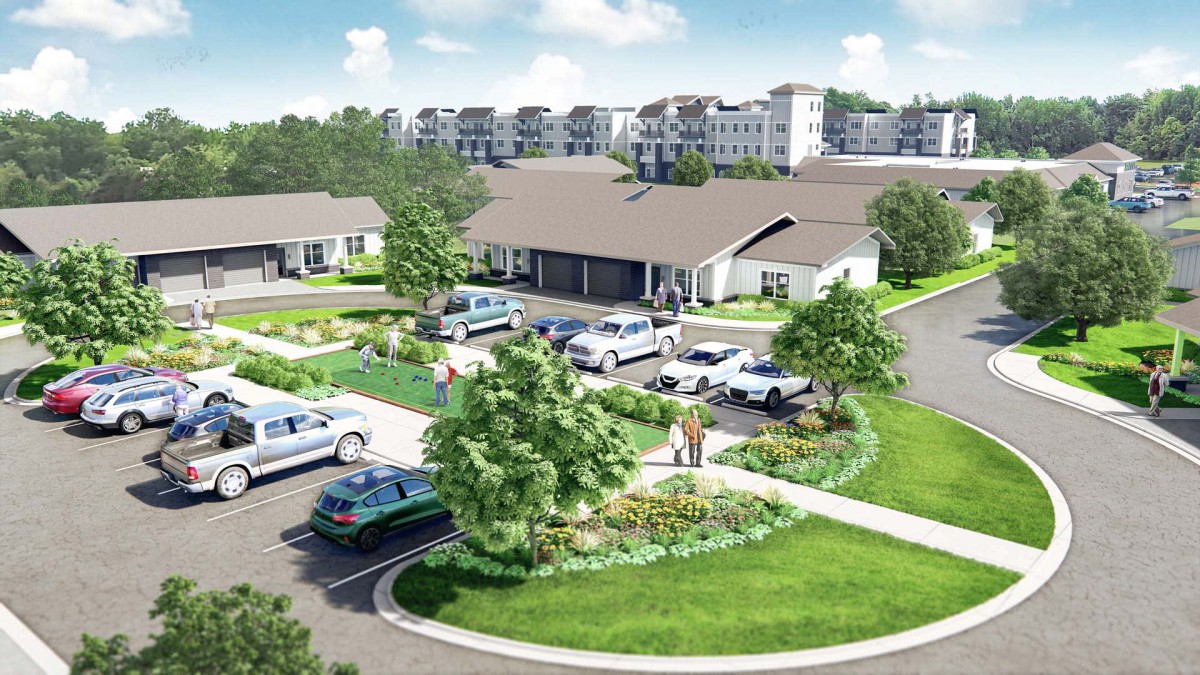 An aerial view of a residential housing complex with landscaped gardens and parking facilities.