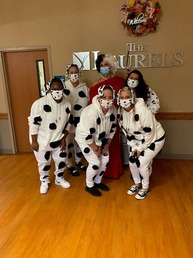 A cheerful group sporting cow-themed costumes poses for a fun photo.