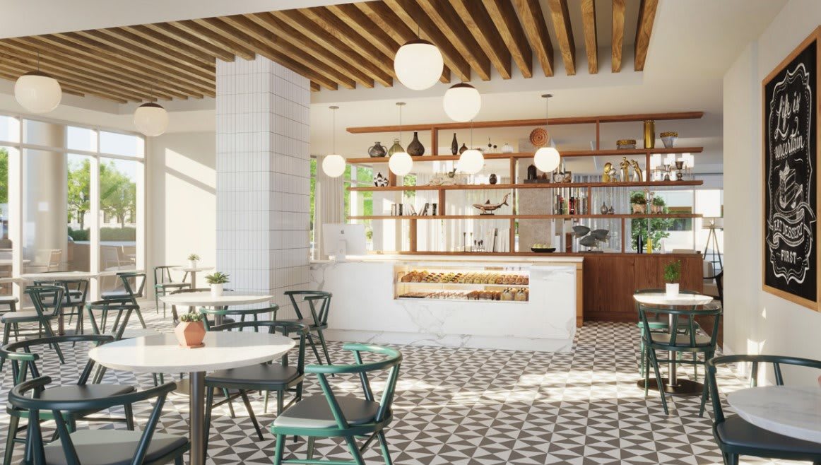A modern cafe interior with stylish decor and ample natural lighting.