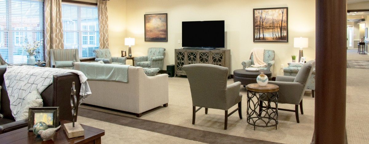 A cozy living room with comfortable seating and a large TV.