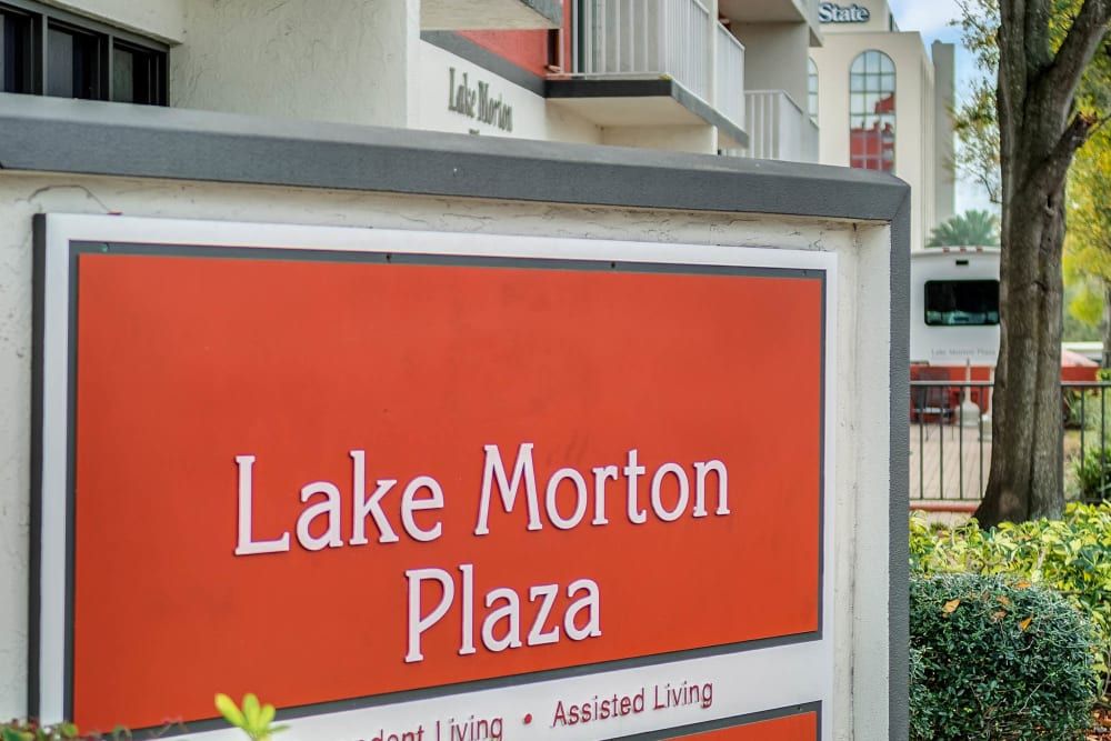 Sign for Lake Morton Plaza in front of residential buildings.