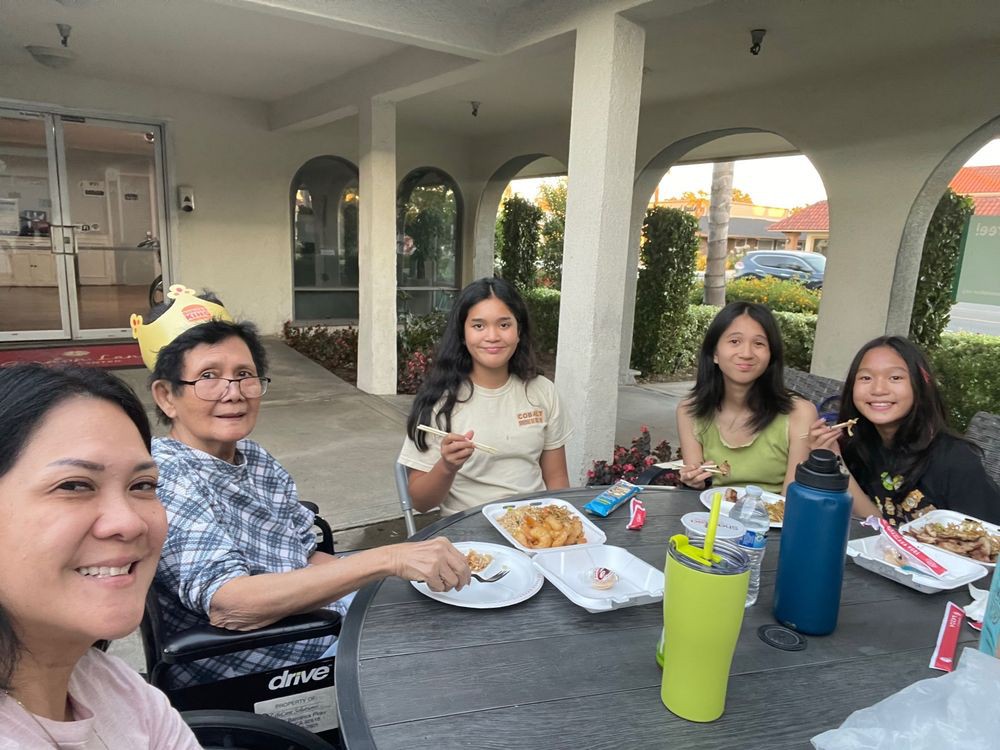 A family enjoying a meal together outdoors.