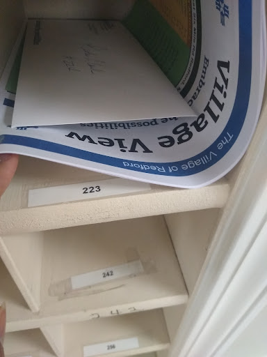A close-up view of a mailbox compartment filled with letters and paperwork.