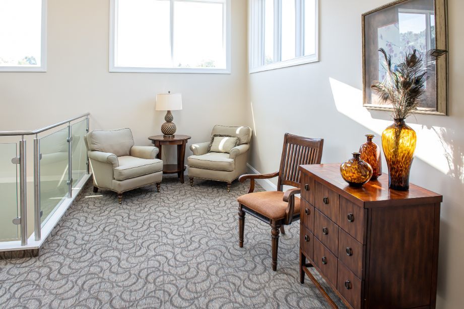 A cozy living room area with comfortable seating, natural light, and tasteful decor.