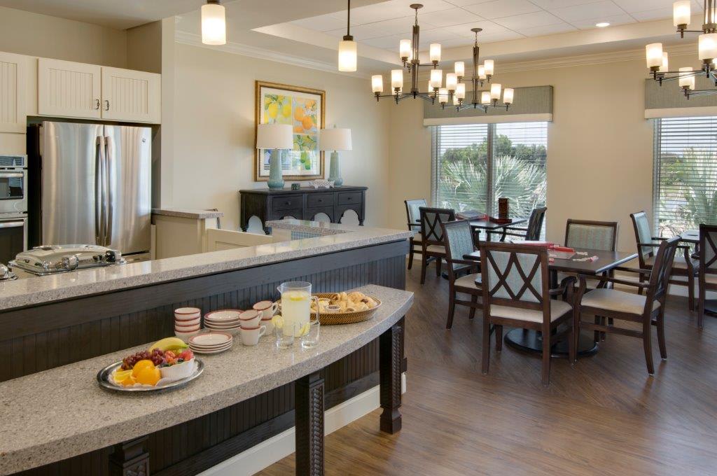 A cozy dining area with a breakfast buffet setup and elegant chandeliers.