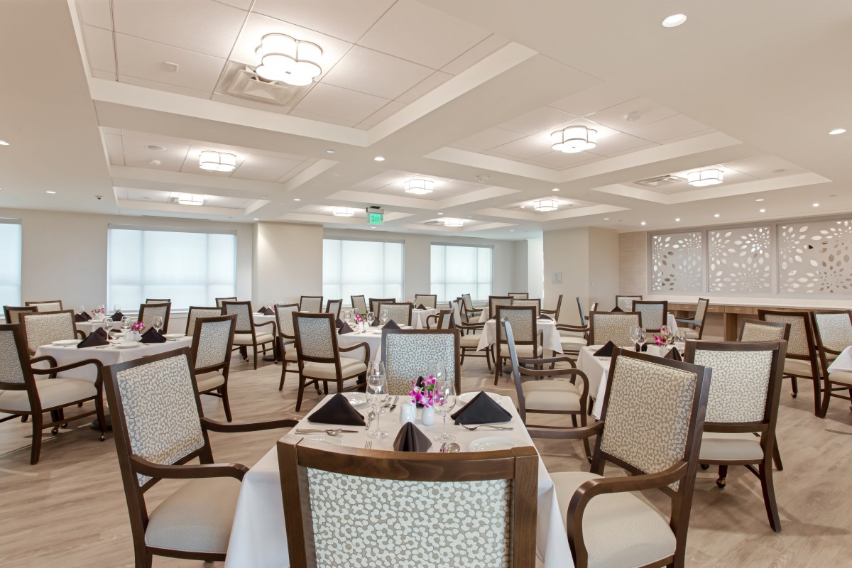 An elegant dining area with neatly arranged tables and chairs.