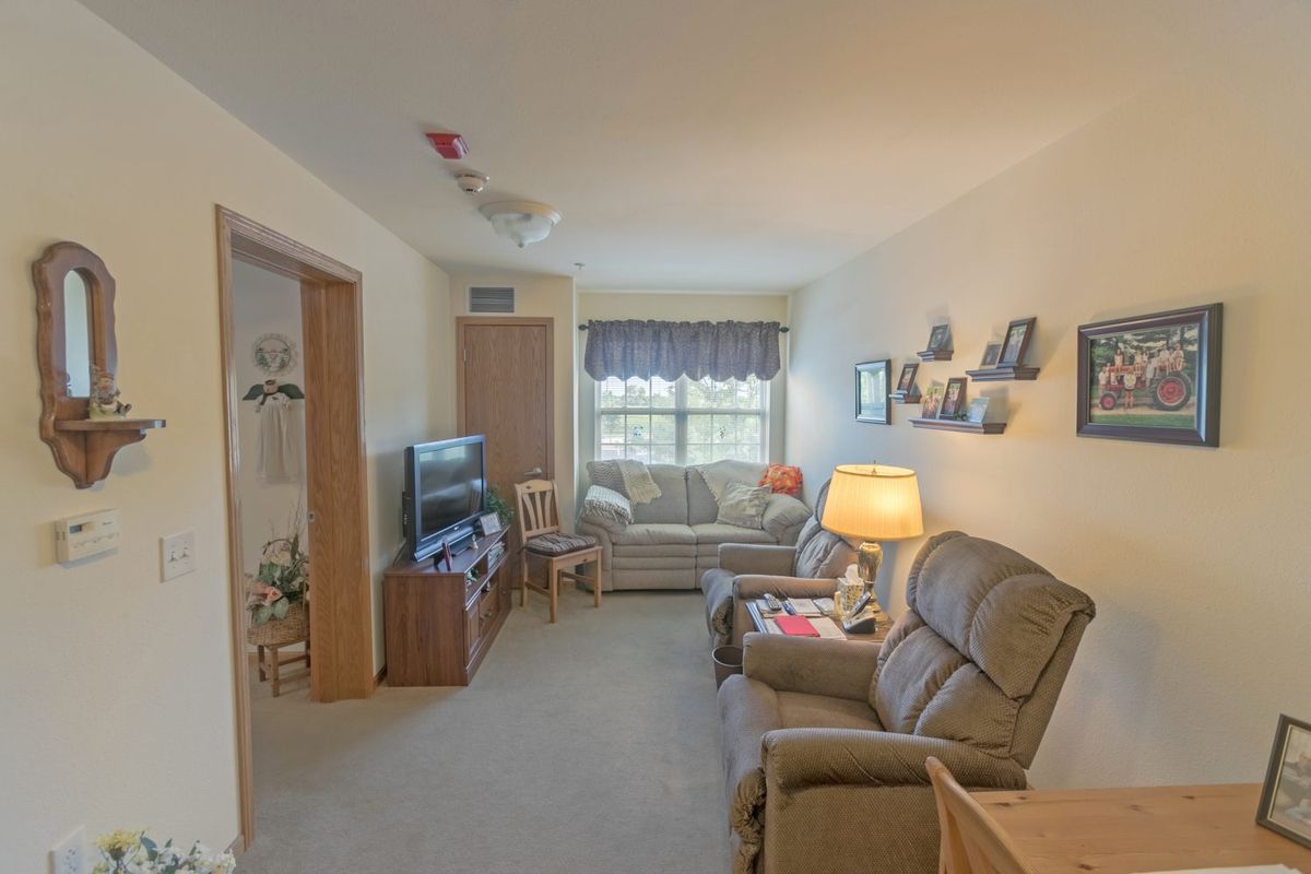A cozy living room featuring comfortable seating, a television, and decorative elements.