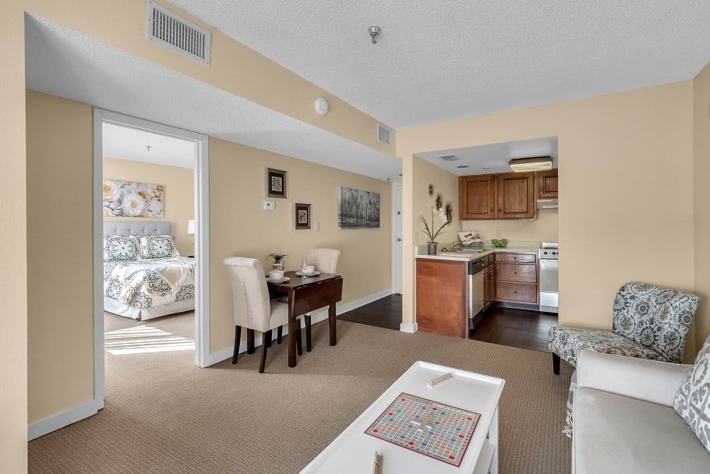 Cozy apartment with an open layout featuring a dining area, kitchen, and adjacent bedroom.