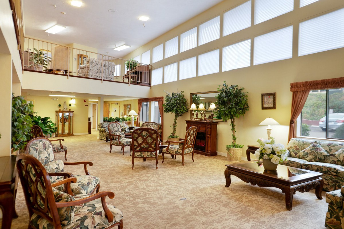 A spacious hotel lobby with elegant furniture and warm lighting.