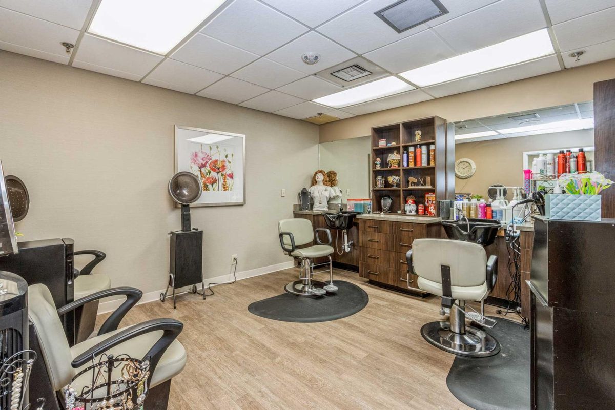 An inviting hair salon equipped with comfortable chairs and a range of hairdressing products.