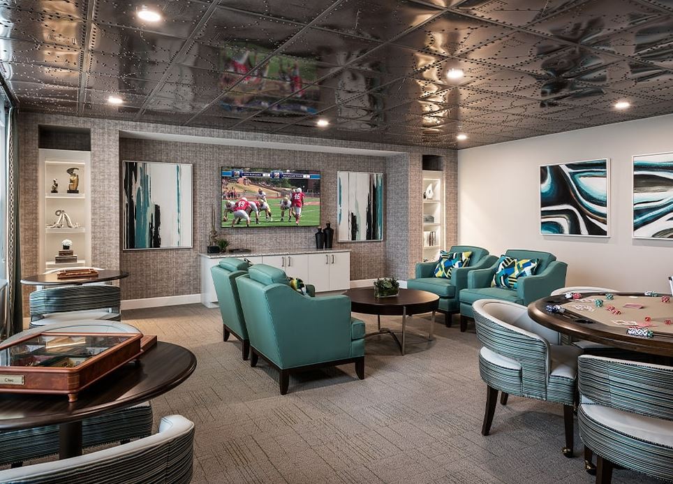 A modern living room with a home theater setup and stylish seating arrangement.