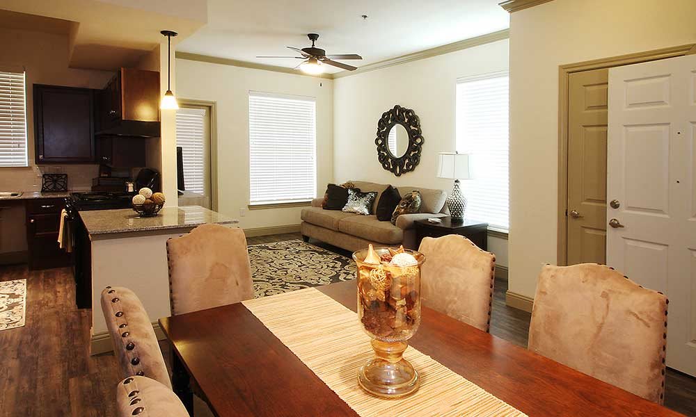 A contemporary living room with a dining area, featuring modern furniture and elegant decor.