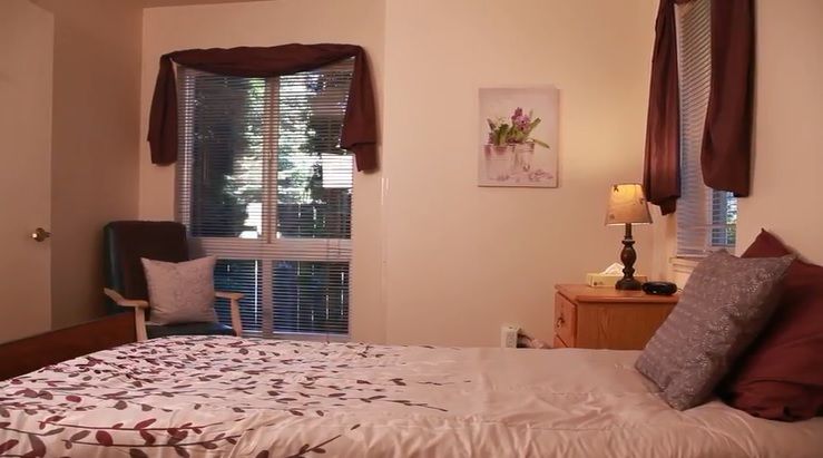 Cozy bedroom with natural light and simple decor.