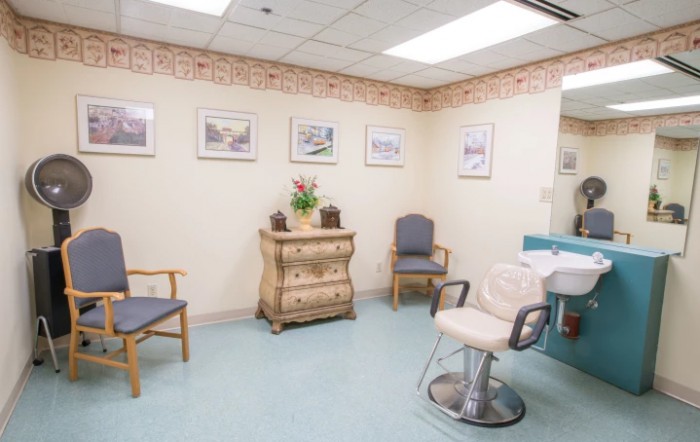 A cozy hair salon interior with chairs and decor.