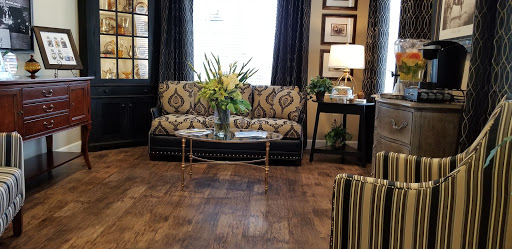 A beautifully designed living room featuring a patterned sofa, floral centerpiece, and elegant decor.