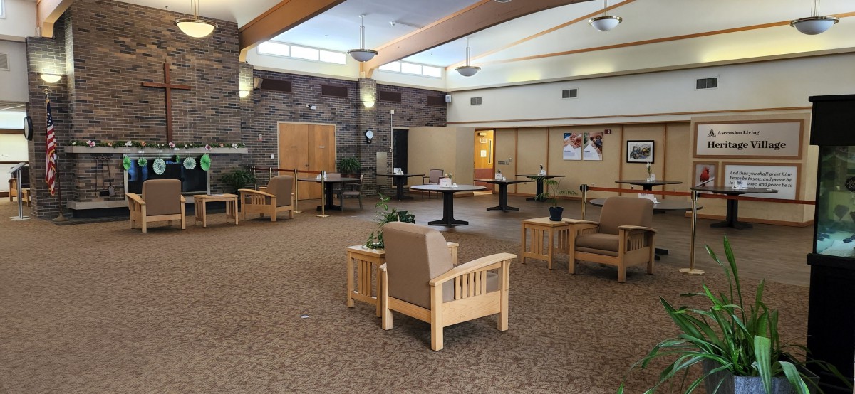 A modern waiting room with comfortable seating and tables.
