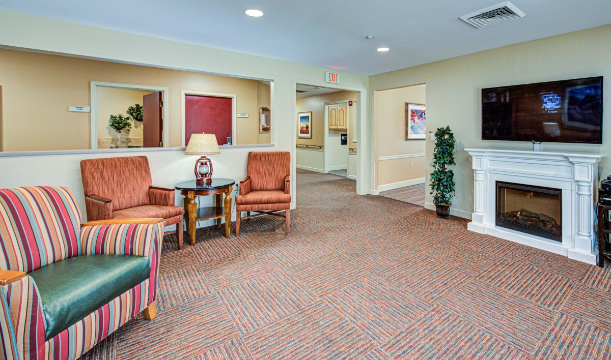 A warmly decorated lobby with comfortable seating and wall art.