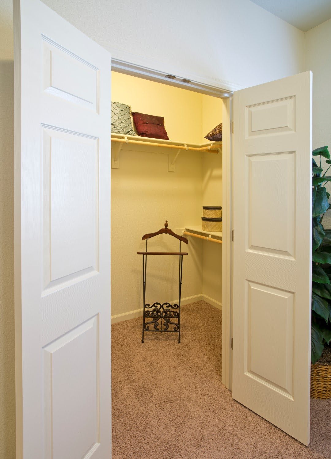 An open closet with shelves and hangers, showcasing organized storage space.