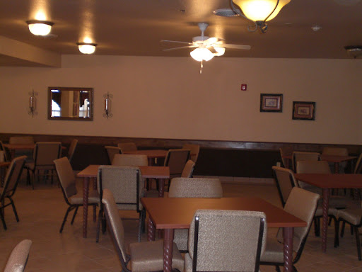 A spacious dining area with tables and chairs arranged for guests.