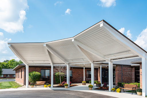 A modern entrance with a unique canopy design and well-maintained landscaping.