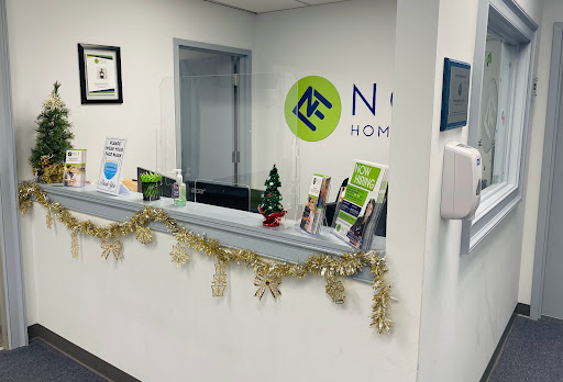 A modern office reception area decorated with holiday accents.