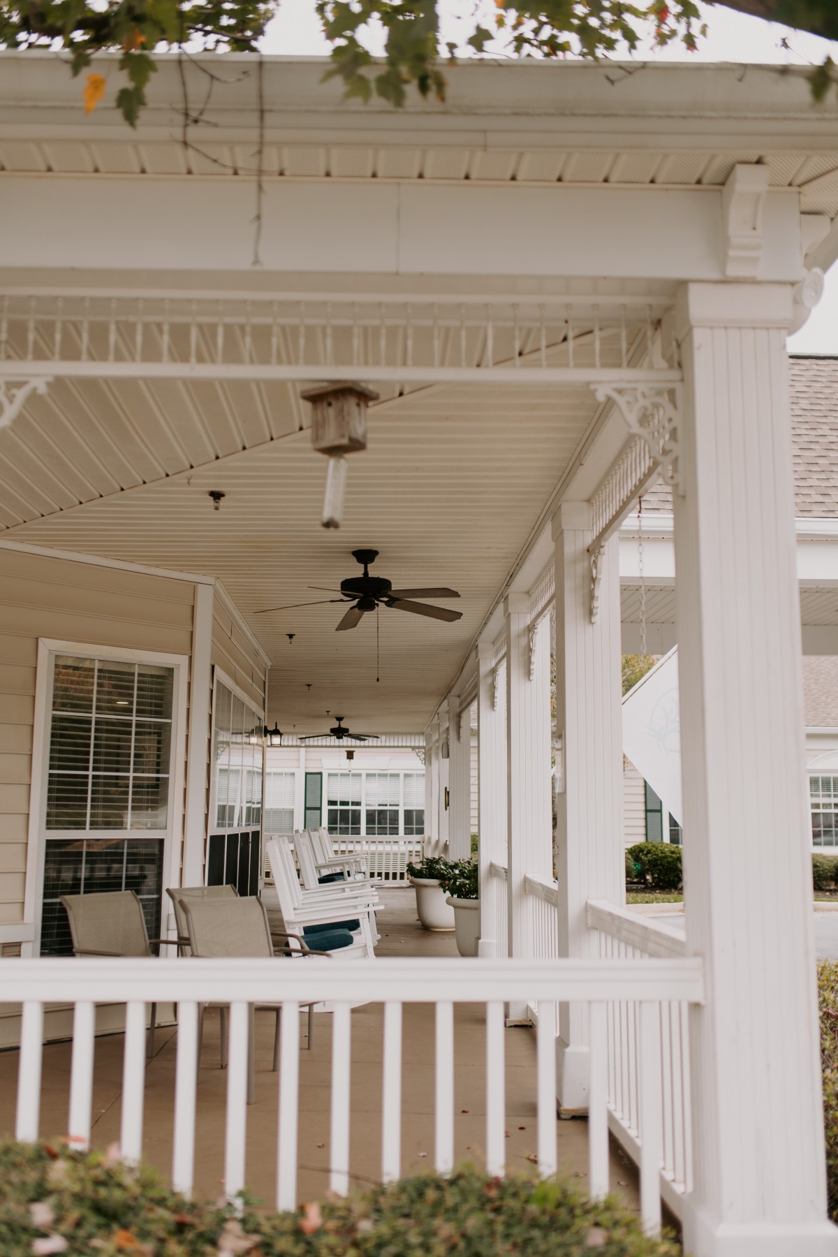 A cozy porch with ceiling fans and seating, perfect for relaxation.