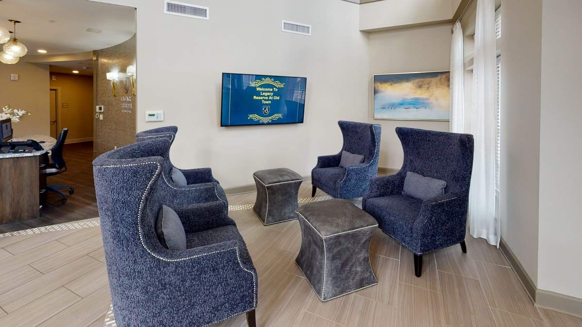 A modern lounge area featuring blue armchairs and a stylish interior design.