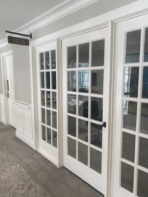 A modern office interior featuring white glass doors.