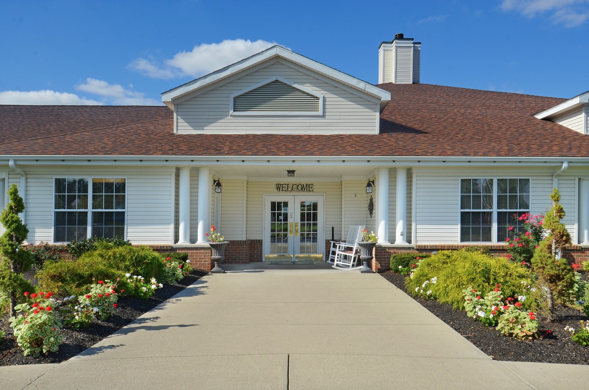 A residential building with a welcoming entrance and neatly landscaped surroundings.