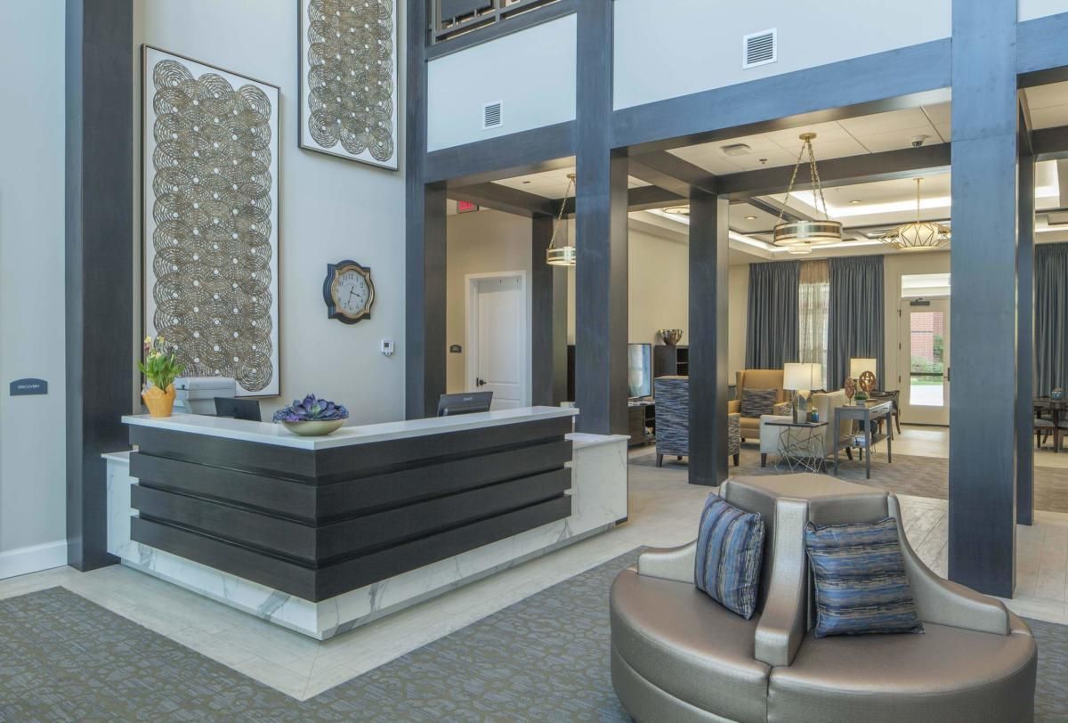 A modern lobby area with a reception desk and comfortable seating.