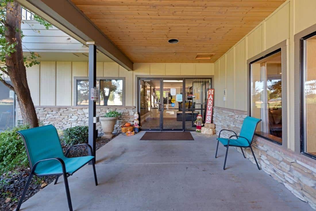 An inviting entrance with outdoor seating and decorative items.