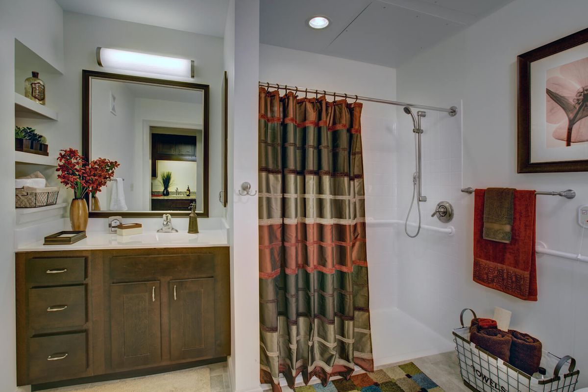 A modern bathroom with a colorful shower curtain and stylish vanity.