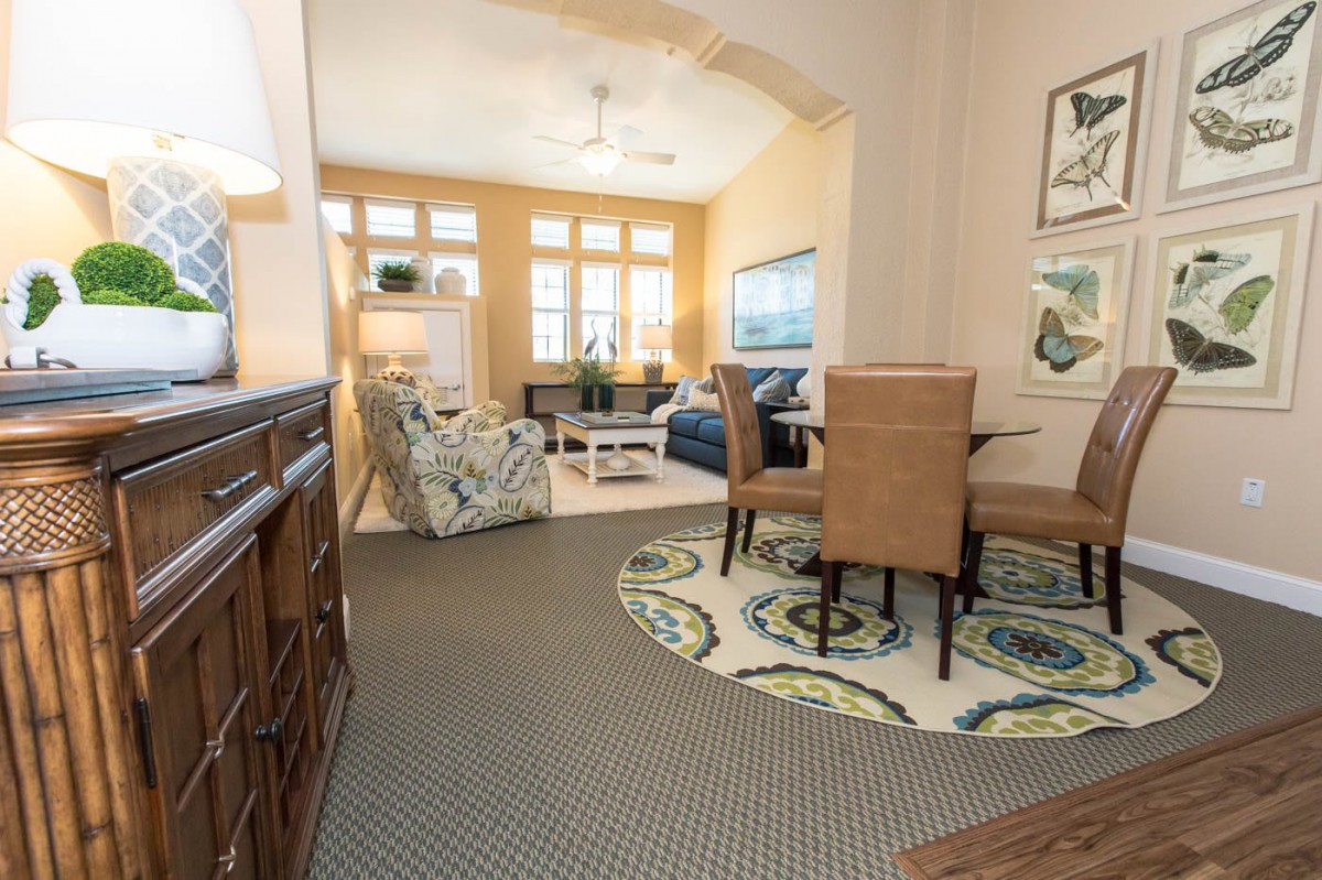 A cozy living and dining area featuring modern furniture and decorative artwork.