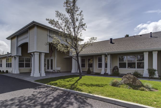 A residential house with a front yard and driveway.
