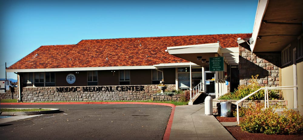 Entrance of a medical center with distinctive architectural features.