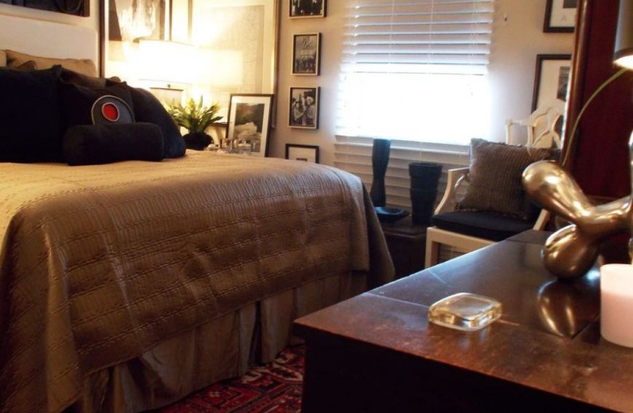 A cozy and well-decorated bedroom with a comfortable bed, warm lighting, and stylish furnishings.