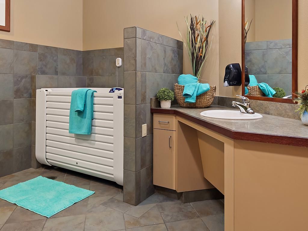 A modern bathroom with turquoise accents and a sleek design.