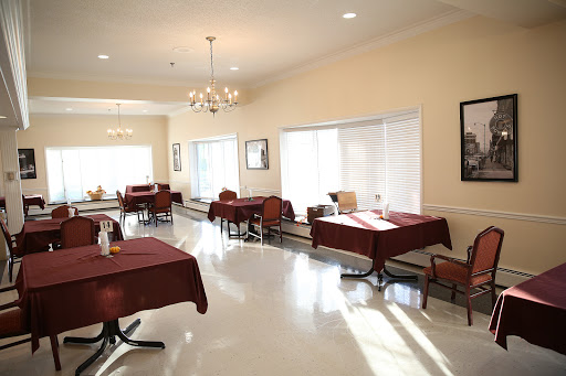 A bright and inviting dining area featuring neatly arranged tables and chairs.