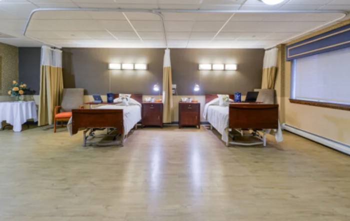 A hospital ward with neatly arranged beds and medical equipment.