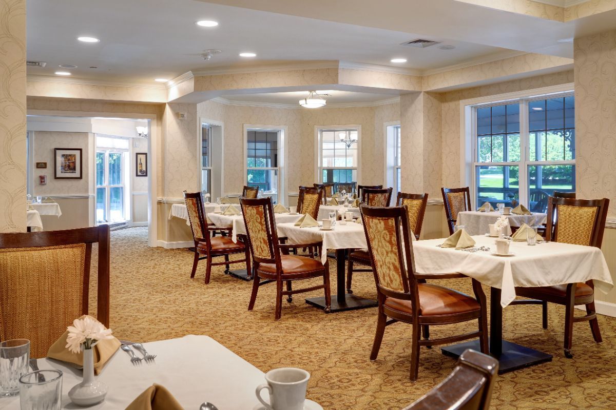 An elegant dining room with neatly arranged tables and chairs.