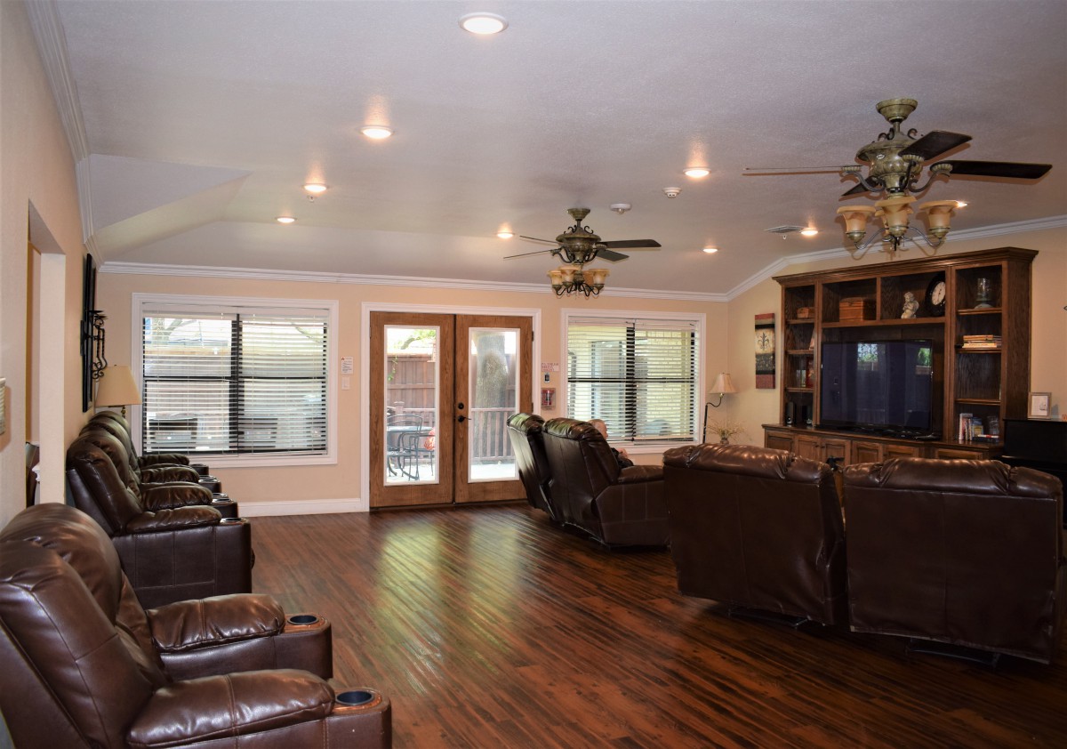Spacious living room with wood flooring, comfortable seating, and modern decor.