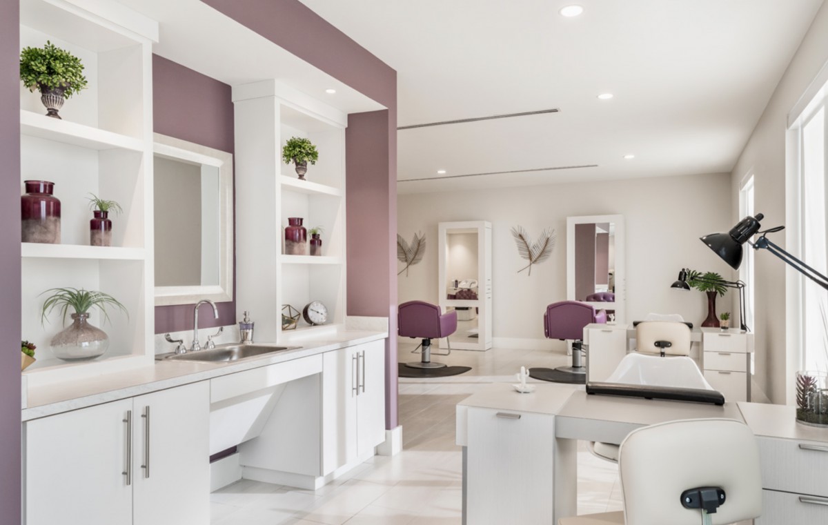 A modern and luxurious beauty salon interior with purple accents and stylish furniture.