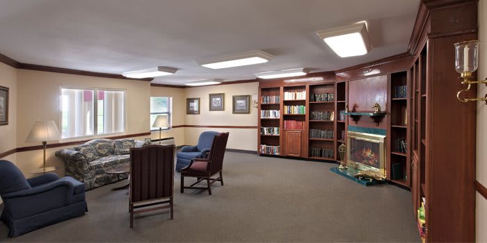 A cozy library corner with bookshelves and comfortable seating.