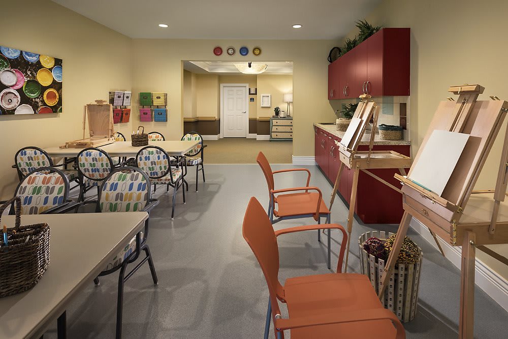 A well-equipped art room with chairs, tables, and easels ready for creative projects.