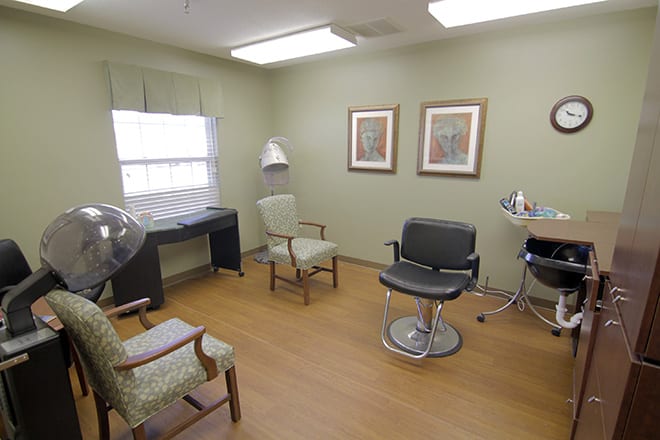 A well-organized hair salon interior with stylish chairs and salon equipment.