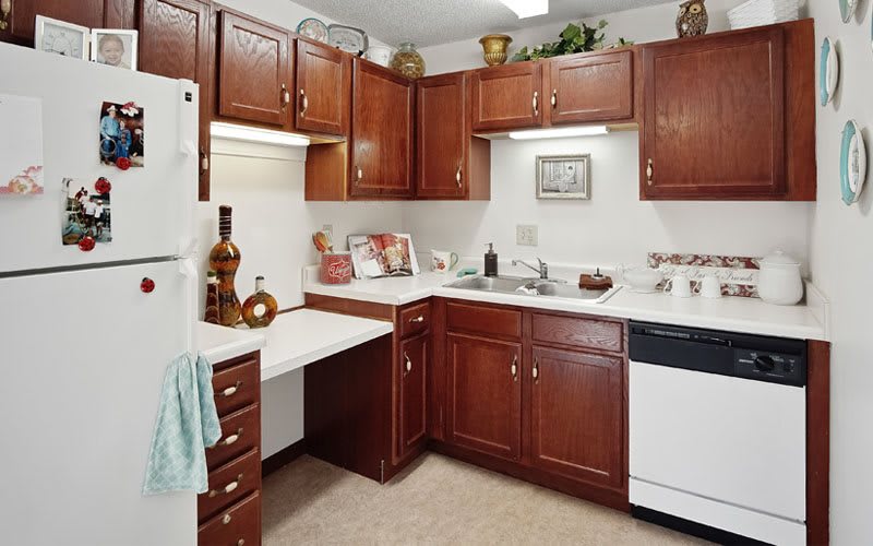 A cozy kitchen with wooden cabinets and various appliances.
