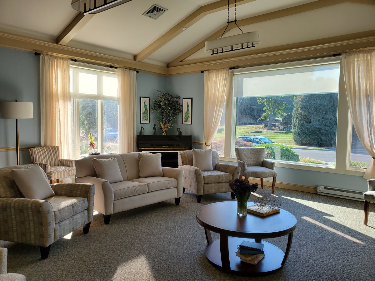A cozy living room with plush seating and abundant natural light streaming in through large windows.